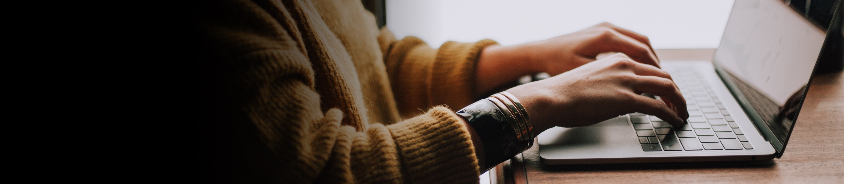 Woman typing at laptop